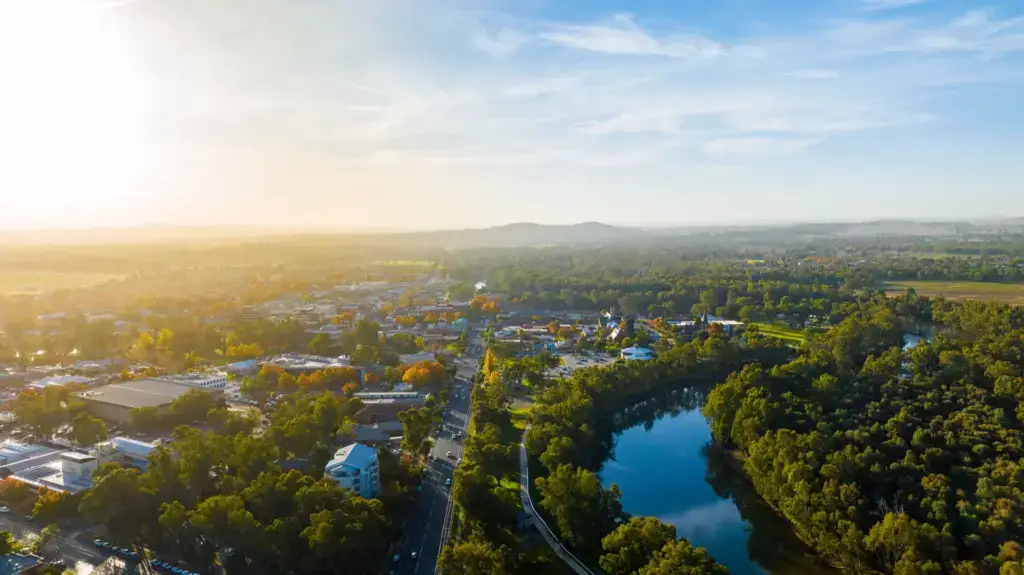 Aerial view of small town by river at sunrise